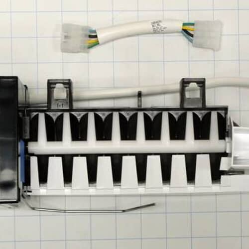 Close-up of the icemaker mold tray section showing the white and black ejector blades, set against a white grid background.