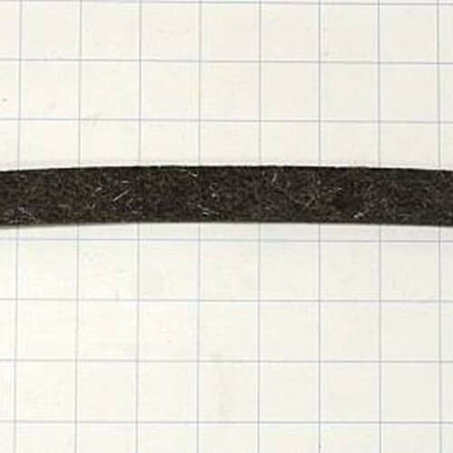 The gray felt dryer seal strip lying straight across a white grid background, showing its width and texture.