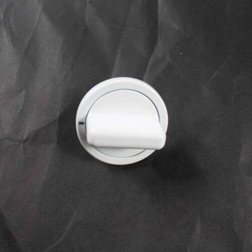 A close-up, slightly angled view of the white GE timer knob resting on a dark, wrinkled surface.
