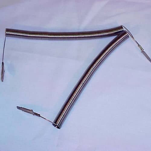 A GE dryer heating element assembly showing the two intertwined metal coils forming a 'V' shape against a light blue surface.