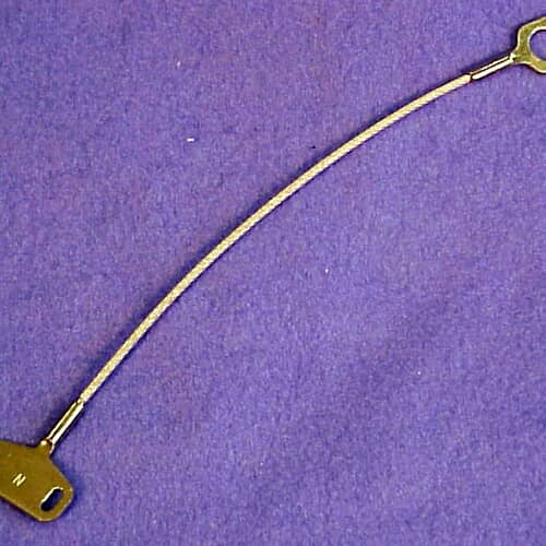 Close-up of GE WD7X14 dishwasher door cable assembly showing steel wire and metal ends.