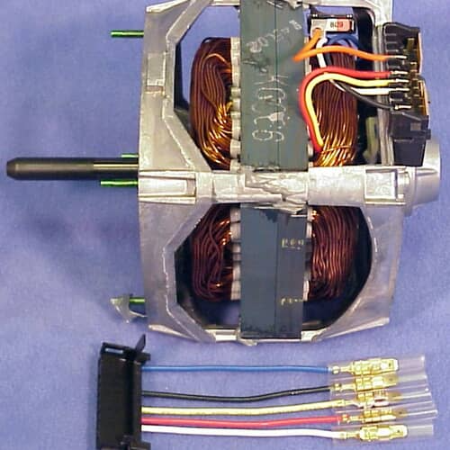 Side view of the motor casing, showing the output shaft and electrical wiring harness terminals.