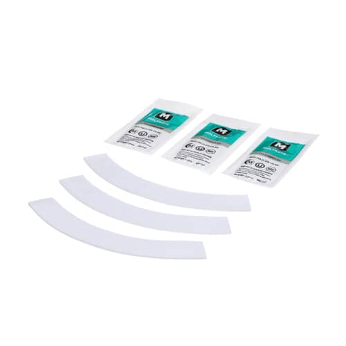 Three curved white appliance damper pads resting on a purple fabric surface