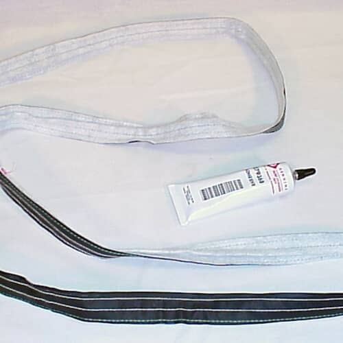 A close-up, flattened view of the gray and black fabric seal next to the adhesive tube against a white background.