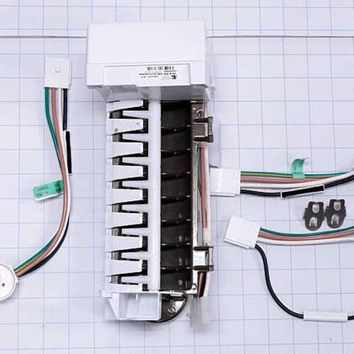 A white icemaker assembly lying on a white grid, showing the mold tray, motor housing, and multiple detached wire harnesses and clips.