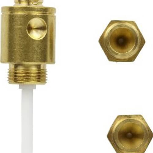 Close-up of the brass caps from the conversion kit showing the small orifice holes for gas flow regulation.