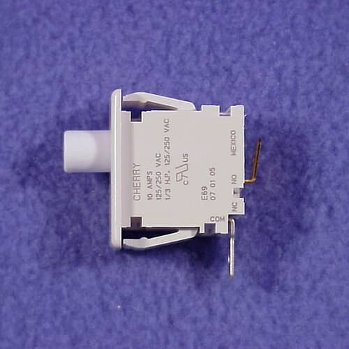 A side profile view of the switch showing the white actuator plunger and the electrical terminals protruding from the black contact block.