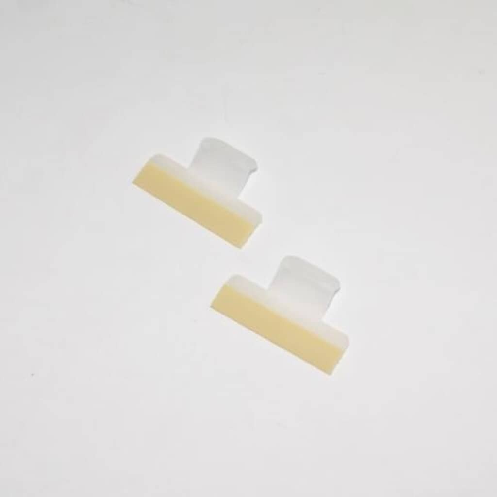 Front view of the two clear, plastic Electrolux 154701001 Dishwasher Splash Shields, showing the central adhesive strip and the extended tabs for easy positioning.