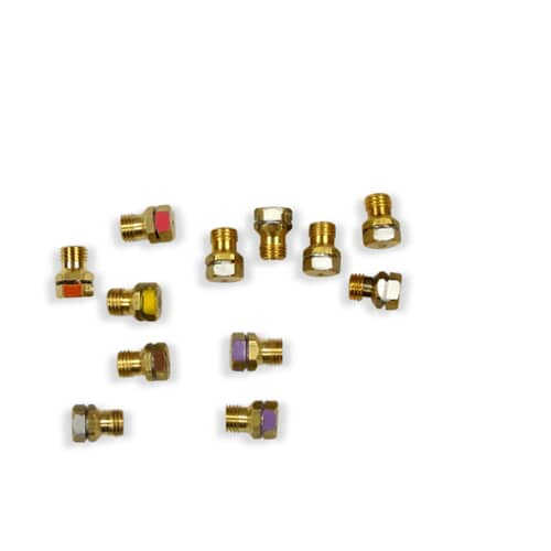 Close-up view of various color-coded brass LP orifices included in the Electrolux 316542414 gas conversion kit.