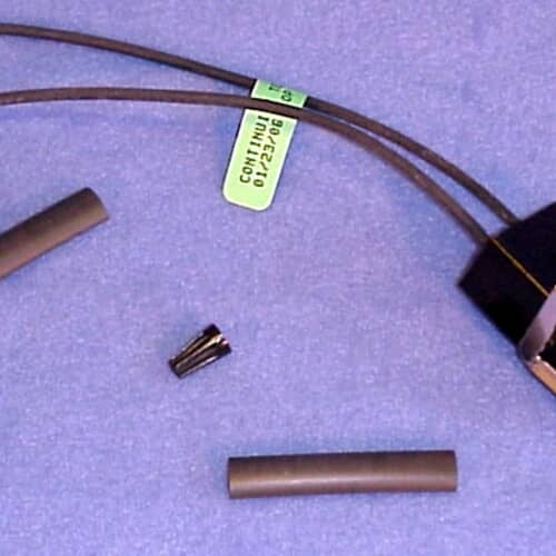 Close-up of the wire leads, wire nuts, and heat shrink tubing included with the GE WB17X5113 terminal block kit.