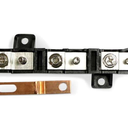 Black terminal block and copper jumper strap.