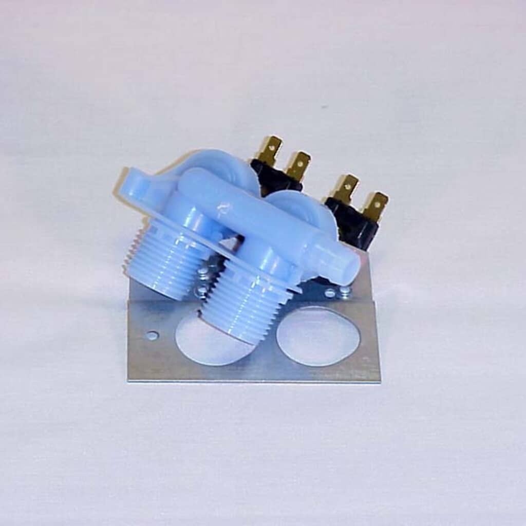 Side angle view of the Whirlpool 285805 Washer Inlet Valve and mounting bracket, highlighting the dual threaded inlets with visible sediment screens, the plastic hose outlet barb, and the two solenoid coils that control hot and cold water flow.