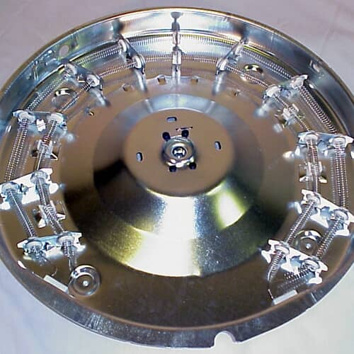 Overhead view of the heater housing assembly against a light background, detailing the metal plate structure that supports the coils.