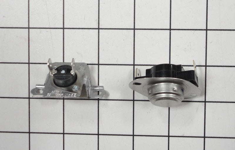 A pair of Whirlpool dryer thermal safety components resting on a white grid background, one showing a silver metal casing and the other a black casing with a red sticker.