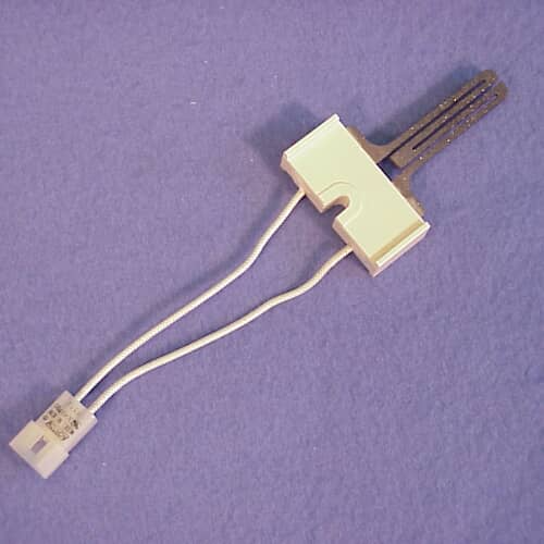 Close-up of the igniter element itself—two dark gray, pronged heat elements extending from the white ceramic base.