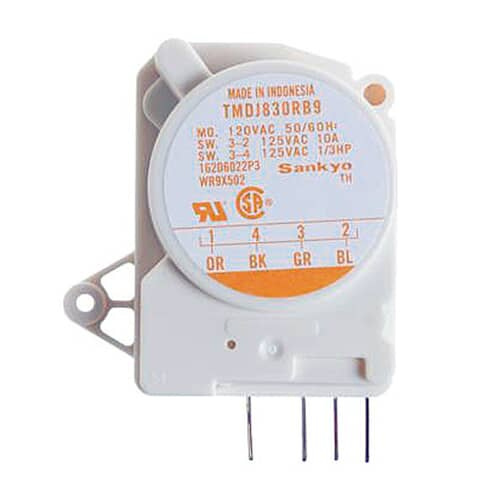 Angled view of the timer assembly showing the white housing, silver mounting bracket, and the orange-labeled dial face.