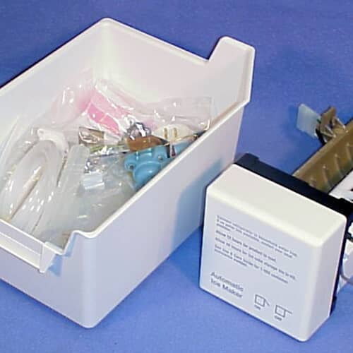 A close-up view of the assembled ice maker unit showing the module, ejector mechanism, and the clear fill tubes nearby.